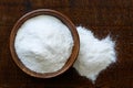 White rice flour in dark wooden bowl isolated on dark brown wood Royalty Free Stock Photo