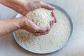 white rice in old hand And in a plate on the table Royalty Free Stock Photo