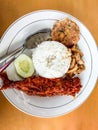 White rice with Sambal fish, cakes, jackfruit and cucumber very delicious food