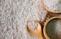 White rice seed with two brown wooden bowl and wooden spoon on rice background. Organic, natural long rice grain, food raw for hea Royalty Free Stock Photo