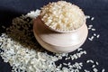 White rice in a wooden bowl isolated on a black background. Rice is common food of Asian people