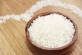 White rice in a wooden plate and rice pattern in the shape of a heart Royalty Free Stock Photo