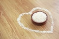 White rice in a wooden plate and rice pattern in the shape of a heart Royalty Free Stock Photo