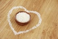White rice in a wooden plate and rice pattern in the shape of a heart Royalty Free Stock Photo