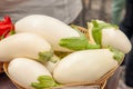 White ripe fresh eggplant lying in a wicker basket at the farmers market. Elite and modern varieties and hybrids of vegetables Royalty Free Stock Photo