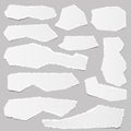 White ripped blank note paper strips for text or message stuck on gray background.