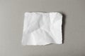 White ripped note, blank of torn crumpled paper on gray