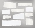 White ripped striped note, copybook, notebook paper stuck on light gray background. Royalty Free Stock Photo