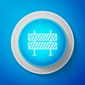 White Road barrier icon isolated on blue background. Symbol of restricted area which are in under construction processes Royalty Free Stock Photo