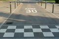 White road marking on the road of 30 km/h zone as a form of speed management used across areas of urban roads.