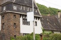 White road sign in front of the Moselkern train station - Gothic architecture