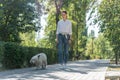 White roan elderly English Cocker Spaniel being walked park with owner young woman