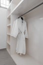 White robes with wooden hangers at dressroom. Royalty Free Stock Photo