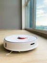 White robot cleaner. Robot vacuum cleaner on laminate floor in action Royalty Free Stock Photo