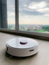 White robot cleaner. Robot vacuum cleaner on laminate floor in action Royalty Free Stock Photo