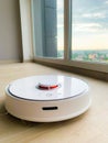 White robot cleaner. Robot vacuum cleaner on laminate floor in action Royalty Free Stock Photo