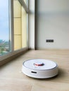 White robot cleaner. Robot vacuum cleaner on laminate floor in action Royalty Free Stock Photo