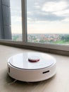 White robot cleaner. Robot vacuum cleaner on laminate floor in action Royalty Free Stock Photo