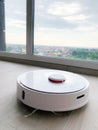 White robot cleaner. Robot vacuum cleaner on laminate floor in action Royalty Free Stock Photo