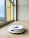 White robot cleaner. Robot vacuum cleaner on laminate floor in action Royalty Free Stock Photo