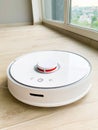 White robot cleaner. Robot vacuum cleaner on laminate floor in action Royalty Free Stock Photo