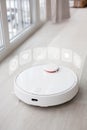 White robot vacuum cleaner with interactive holographic menu