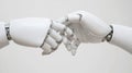 A white robotic hand reaching out to another.