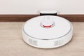 White robotic vacuum cleaner charging battery