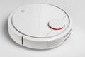 white robotic vacuum cleaner. The robot is controlled by voice commands for direct cleaning. Modern technology of smart cleaning