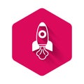 White Rocket ship icon isolated with long shadow background. Space travel. Pink hexagon button. Vector Royalty Free Stock Photo