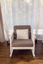 White rocking chair with brown cushion in the interior Royalty Free Stock Photo