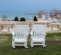 White rocking chairs overlooking the lake