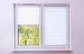White roller blind on a metal plastic window Royalty Free Stock Photo