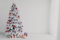 White room Christmas tree with red toys new year winter gifts decor Royalty Free Stock Photo