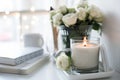 White room interior decor with burning hand-made candle and bouq Royalty Free Stock Photo