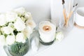 White room interior decor with burning hand-made candle and bouq Royalty Free Stock Photo