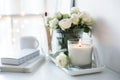 White room interior decor with burning hand-made candle and bouq Royalty Free Stock Photo