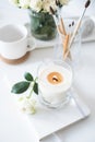 White room interior decor with burning hand-made candle and bouq Royalty Free Stock Photo