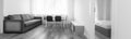White room with sofa, black chairs and white table Royalty Free Stock Photo