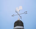 White rooster weather vane show the wind direction on blue sky background Royalty Free Stock Photo