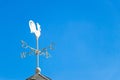 White rooster weather vane show the wind direction on blue sky Royalty Free Stock Photo