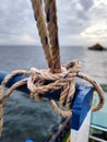 white rope with a binding fiber that binds on the boat 23