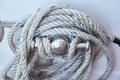 White rope coiled on a wooden boats deck.