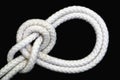 A white rope tied with bowline on a bight knot on black background