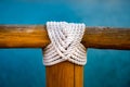 White rope wood cross on blue Royalty Free Stock Photo