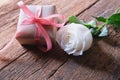 White rose and minimal gift box on vintage wooden table. Lover concept. Perfect for Valentine& x27;s background. Copy space Royalty Free Stock Photo