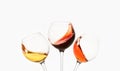 White, rose, red wine splashes, diagonal waves in glasses. Royalty Free Stock Photo