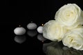 White roses and burning candles on black mirror surface in darkness, closeup with space for text. Funeral symbols Royalty Free Stock Photo