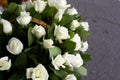 White roses close-up in the basket. A bouquet of beautiful white roses in a wicker basket. Delicate white roses close-up. Royalty Free Stock Photo