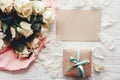 White roses with empty card and gift box on wooden background, f Royalty Free Stock Photo